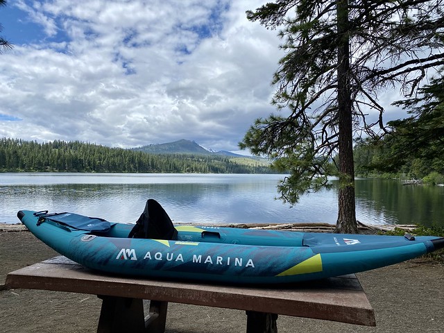 Aqua Marina inflatable kayak on picnic table with Suttle Lake in Central Oregon in the background
