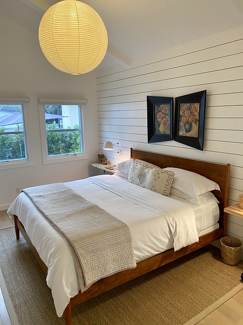 Clean white sheets on a king bed with white painted walls at The Bungalows at Calistoga.