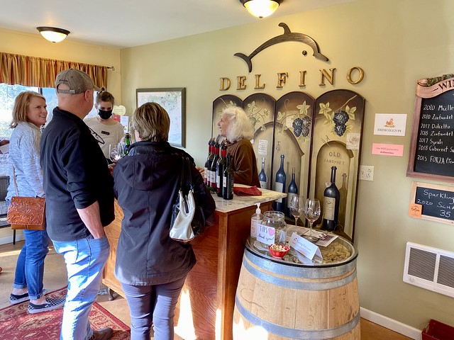 Owner Terri Delfino speaks with guests from behind the tasting room bar at Delfino Vineyards. 