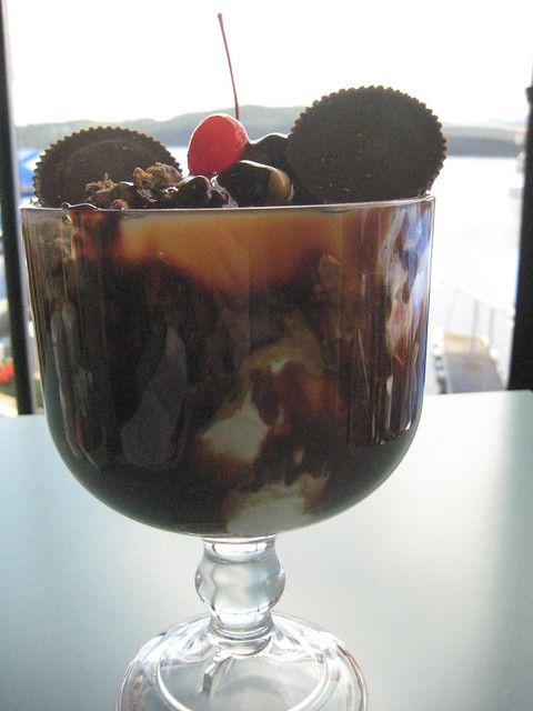 Gooeys huge peanut butter sunday with vanilla ice cream, fudge and peanut butter sauce, 2 Reeses peanut butter cups and a cherry on top with Coeur d'Alene Lake view in Idaho. 