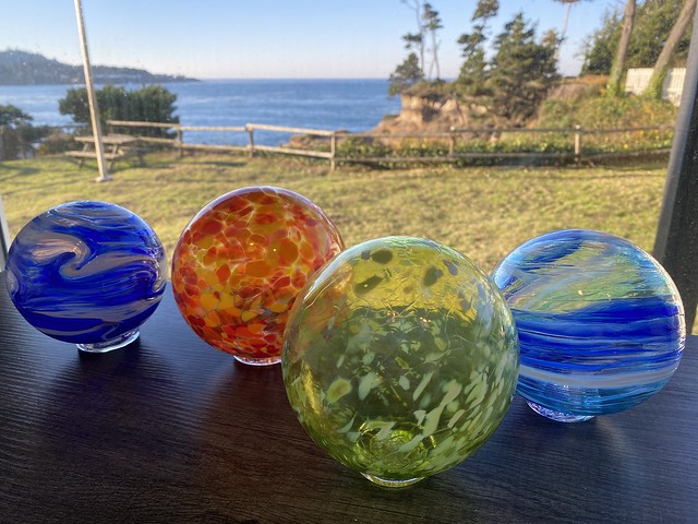 Four multi-colored glass floats are on display in the Inn at Arch Rock breakfast room. Guests are able to visit Lincoln City Glass Center to make these brightly-colored glass floats. 