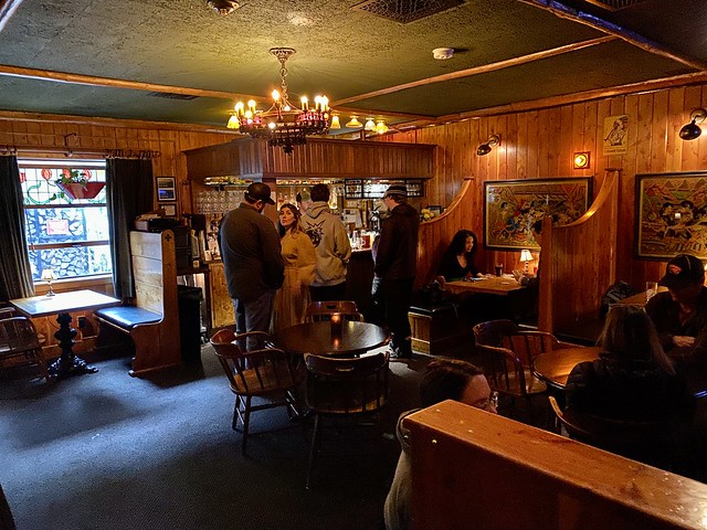 Pub food, beer and cocktails are served at Fireside Bar while people wait for their drinks at McMenamins Old St. Francis School hotel in Bend, Oregon.
