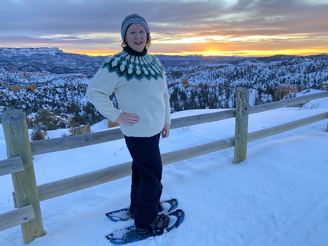 Travel Writer Nancy D. Brown on snowshoes at sunrise with snow-covered Bryce Canyon National Park in Utah. 