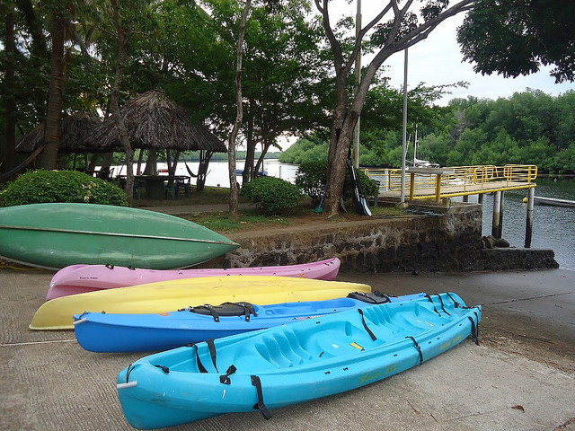 kayaks wait at puerto barillas in el salvador