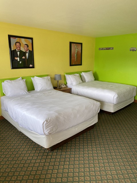 My double room with 2 double beds featured bright yellow and neon green painted walls. Photos of Daniel Rowan and Dick Martin, creators of the tv comedy Laugh-In, hung on the wall above the bed, along with framed pictures of Goldie Hawn, Lillie Tomlin and other television celebrities. 